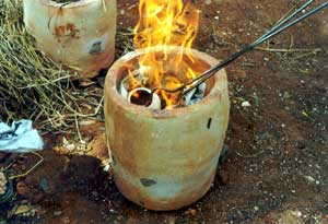 Lifting the pots from the red-hot kiln