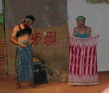Muthu teaching Bapoune how to wear a lungi ..