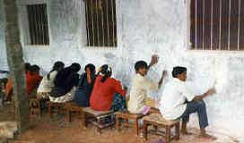 Students white wash the school, work camp