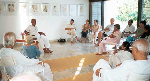 Nirodbaran giving a talk in the hall