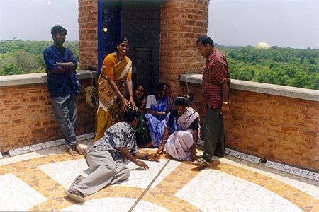 The young trainees enjoy a moment of freedom and relaxation from the roof overlooking Matrimandir