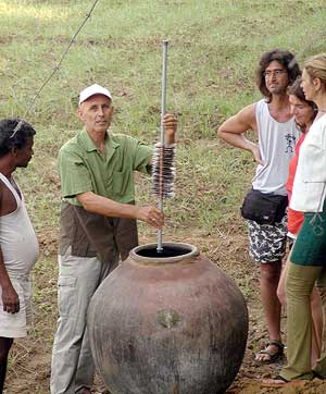 Rolf lowers a vertical array of 24 copper and zinc sheets in a terracotta pot.