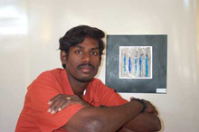 Padmanabhan in front of one of his paintings