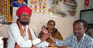 Guruji P. Srinivasaraju reading the pulse of a patient.