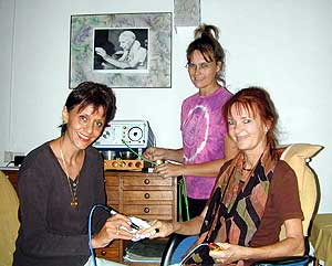 Afsaneh (left) doing an electro-acupuncture diagnostic test on Agnes (right) while Roswitha (middle) operates the Bio-Resonance machine.