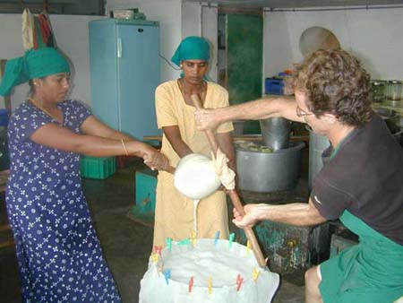 Wrestling to separate the soya milk from the okara. From left to right: Kuppu, Muthulakshmi and Frederic