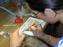 Namgyal works painstakingly on a set of dentures