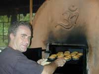 ; Henri taking the freshly baked pastries 'frillantines' from his wood oven