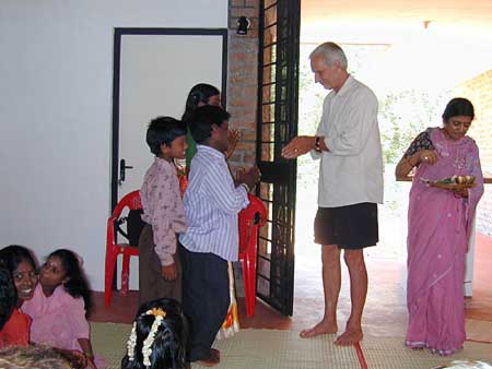 Frederick and Meenakshi handing the keys to the first inhabitants