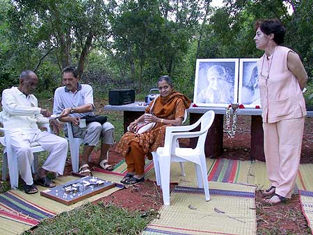Maria Grazia, project holder of Arka, watching Sri Nirodbaran discussing the Arka model at his feet..