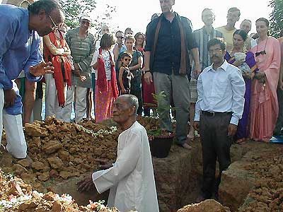 Ananda Reddy communicating with Nirodbaran who is standing in the consecration space..