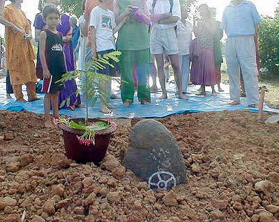 ..a big stone with an Auroville symbol placed on top
