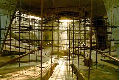 Red stone cladding has begun on the 10th and 11th petals, starting from their bottom lines, which are near the circular pool directly underneath the structure.