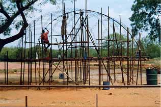 A set of metal ribs forming the skeleton of an egg-shaped dome.. 