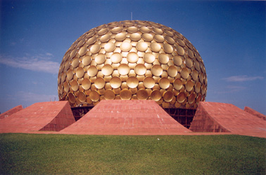 a golden globe arising from the earth..