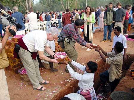 Aurovilians and friends laying a brick.., while others turned to see the arrival of...
