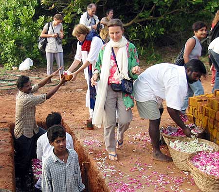 Jaya, main coordinator of the Unity Pavilion, is seen here handing her brick..